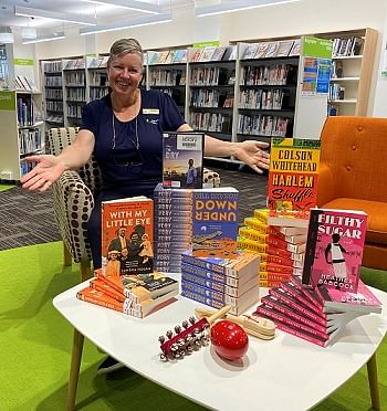 picture of lady showing a selection of books